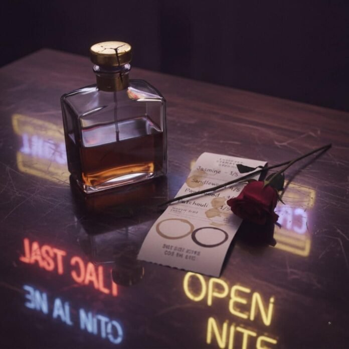 Decanter, receipt, rose, neon bar reflection.